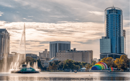 A look at the Orlando skyline and iconic Lake Eola fountain on a cloudy afternoon in Florida.