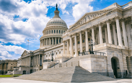 A close-up of the United States Capitol Building in Washington, D.C., in the middle of a semi-cloudy day.