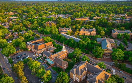 A look down at Williamsburg, Virginia, from above with many brick buildings and trees scattered about.
