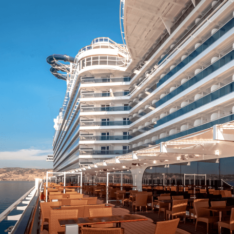 View upwards from the deck of a cruise ship with clear sky in the background