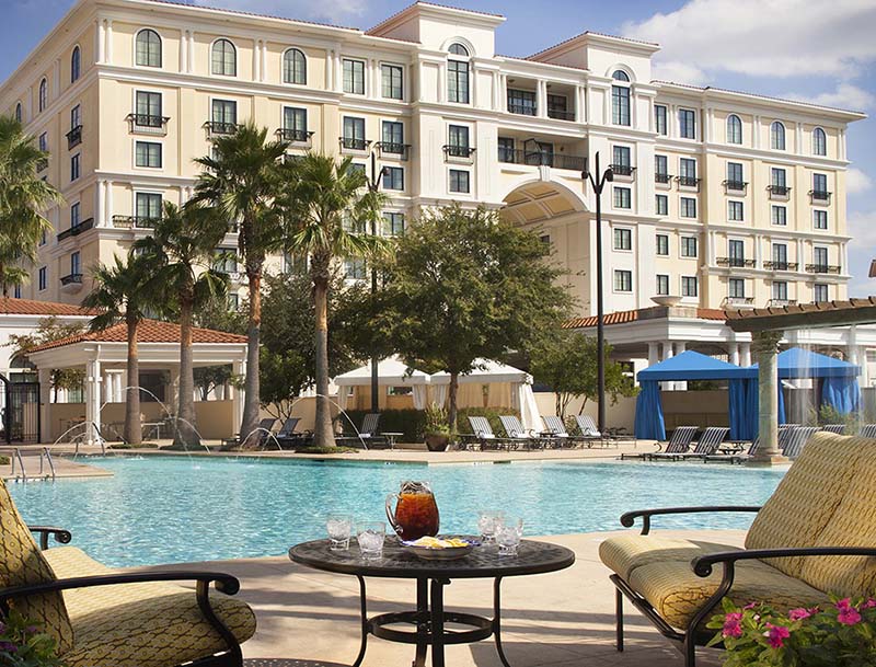 A view of a resort-style pool and cabanas with the Eilan Hotel And Spa in the background.
