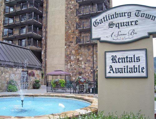 The resort entrance sign and fountain at Gatlinburg Town Square with the resort building visible in the background.