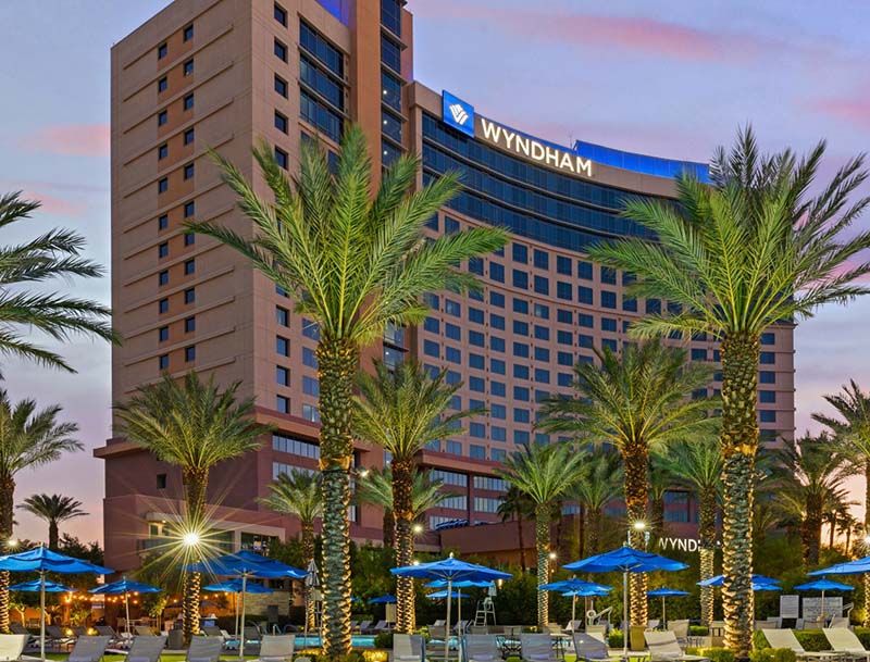 Club Wyndham Desert Blue at dusk with the pool deck area in the foreground.