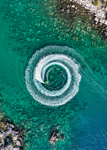 Aerial view of water transport making a circle in the water