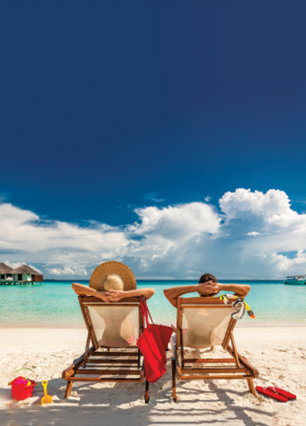 Rear view of two people lying on lounge chairs on the beach, with the sea and clear sky in the background