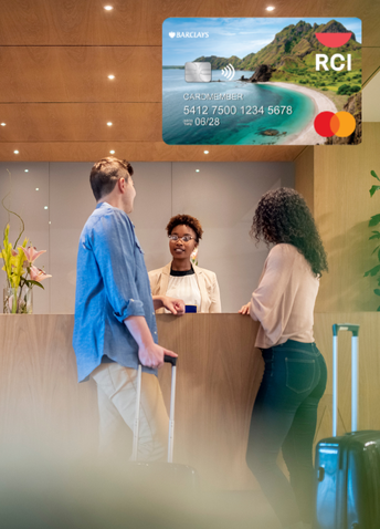Two people checking in at a hotel with an example of the RCI Barclay credit card.