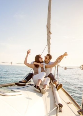 A couple enjoying the weather while sailing.