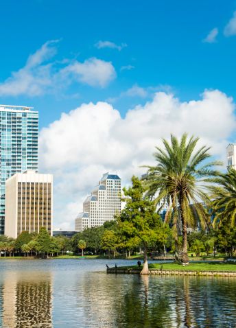 A picturesque afternoon at Orlando's Lake Eola with tall buildings in the distance.